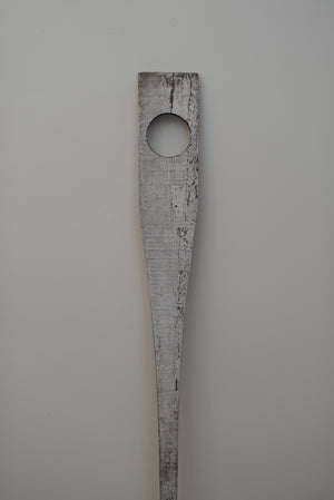James Leonard - The weathered white paddle of Untitled Oar no. 8 is cut through with a perfectly machined 4" hole