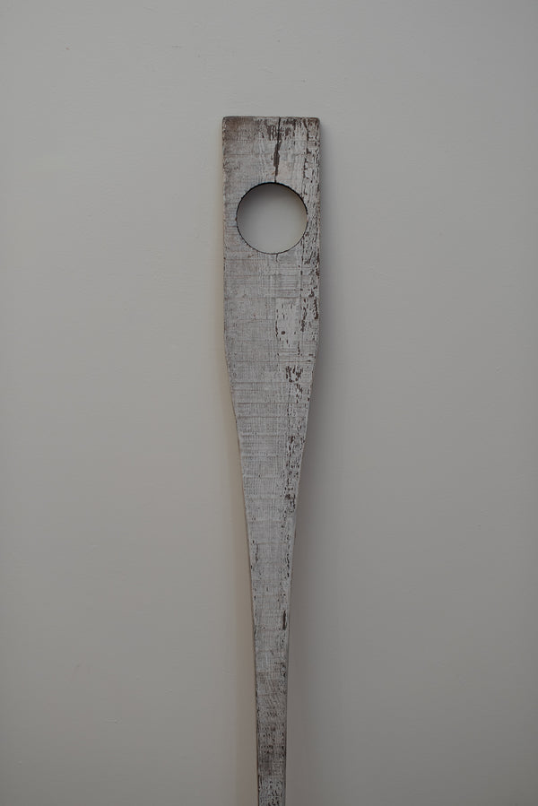 James Leonard - The weathered white paddle of Untitled Oar no. 8 is cut through with a perfectly machined 4" hole