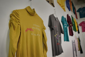 Many T-Shirts with custom texts hang on a studio wall at Sculpture Space, Utica, NY. Art by artist in residence James Leonard.