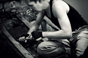 James Leonard carves away a wooden boat in 2013 performance piece. Photo credit Wendy Whitesell.