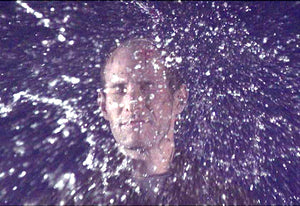 James Leonard - Untitled Water Balloon Portrait Series detail of a man right after being hit in the face with a water balloon; water ricochets off his forehead