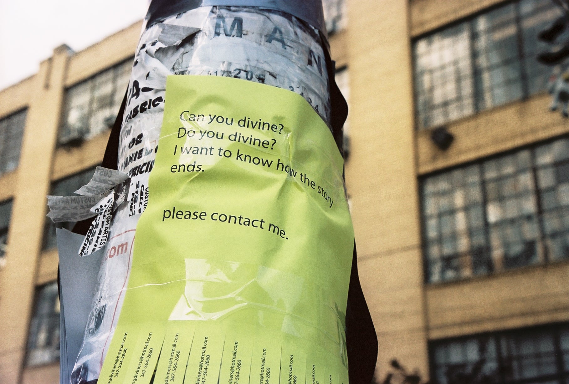 James Leonard - A neon tear-off flier is taped to a telephone pole