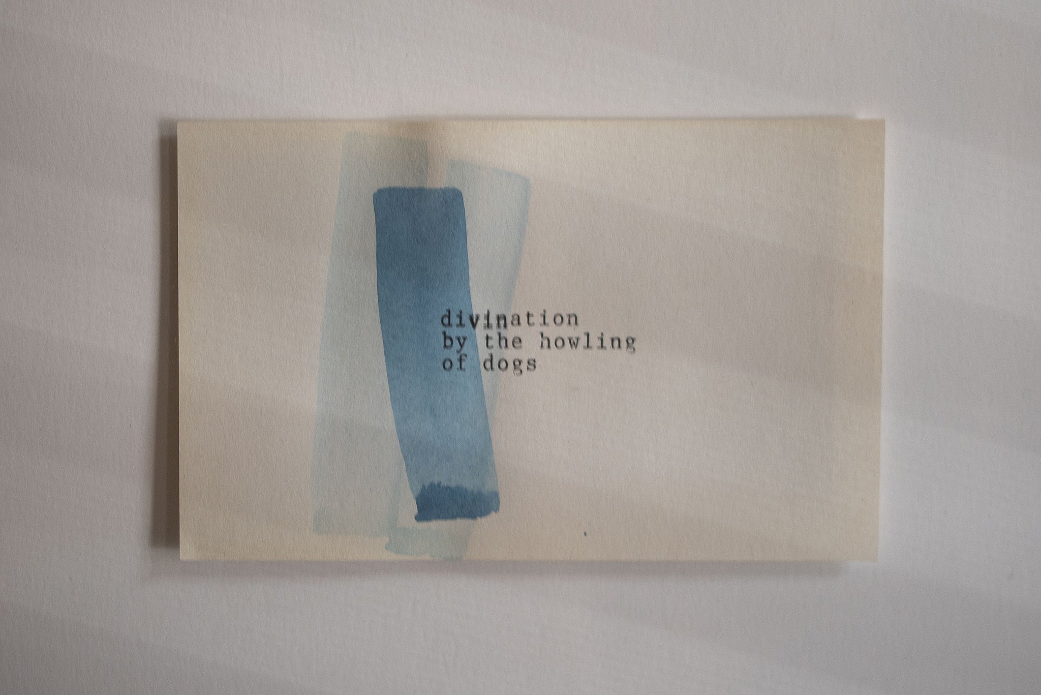 James Leonard - a detail image of a blue watercolor included in the framed set of five, which reads, divination by the howling of dogs