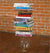 James Leonard - Image of the installation, Lockdown, where a piece of fruit sits encased in a glass vase; resting on top of the vessel is a stack of science textbooks