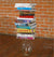James Leonard - Image of the installation, Lockdown, where a piece of fruit sits encased in a glass vase; resting on top of the vessel is a stack of science textbooks