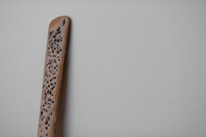 James Leonard - Side angle of sandblasted Untitled Oar no. 6; punctured holes of light are present in the paddle's shadow