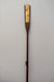 James Leonard - Full image of Untitled Oar no. 7, showing gilded center paddle that has been shot through with bullets; metal hardware is present at the stem