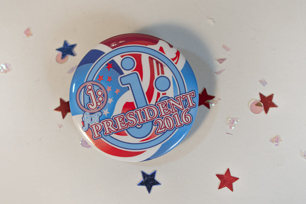 James Leonard - Close up of a metal button that says J: for President 2016, and one of the multiples used in the installation, Hopeful, about the artist's fake bid for presidency