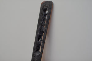 James Leonard - Side angle of Untitled Oar no. 5 paddle, which has many holes due to being burnt my plasma torch