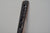 James Leonard - Side angle of Untitled Oar no. 5 paddle, which has many holes due to being burnt my plasma torch