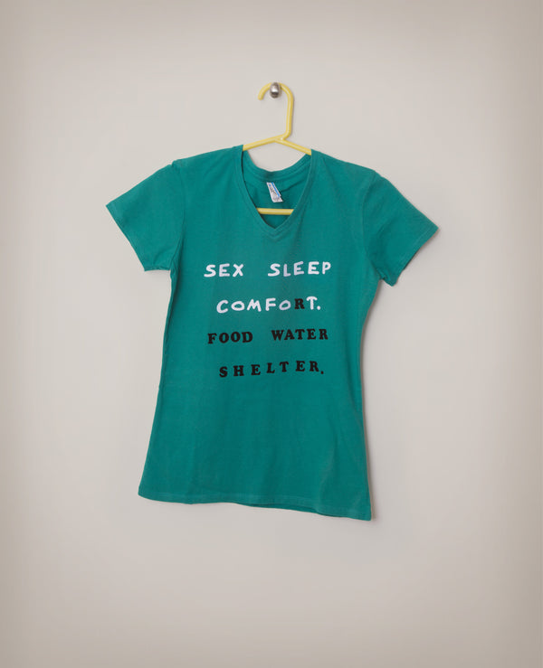 James Leonard - Green shirt that reads: Sex sleep comfort food water shelter