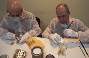 James Leonard - Hector Canonge and Leonard apply gold leaf to trash objects side by side in Transform/Sustain